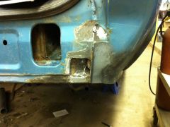 Rust hole bottom right rear corner of car